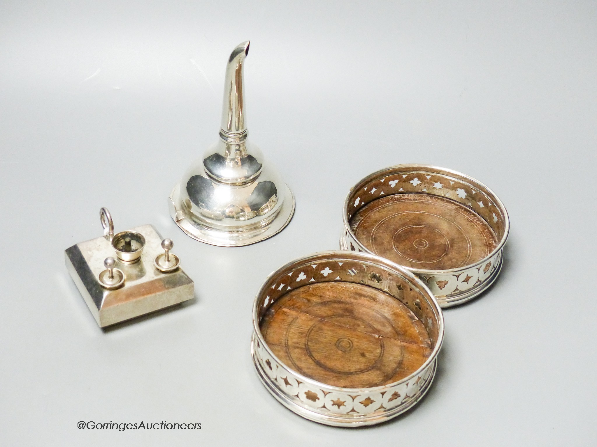 A silver plated wine funnel, a pair of plated coasters and a novelty cigar lamp